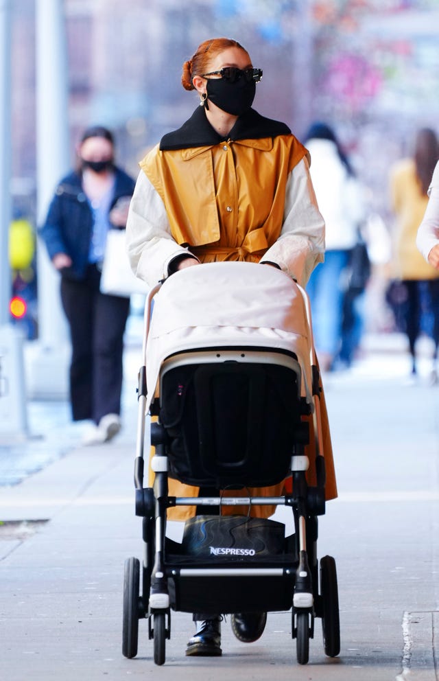 Gigi Hadid Wears Moncler Trench for Stylish Stroll with Baby Khai