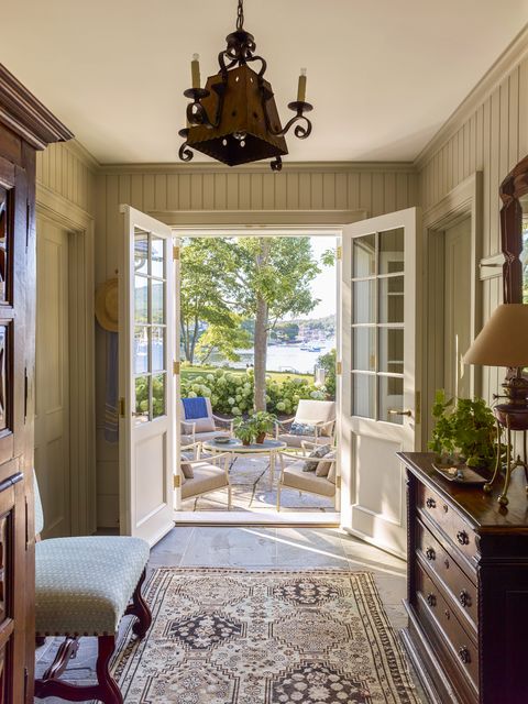 in a connected mudroom wing a bluestone hall leads to a terrace overlooking the harbor