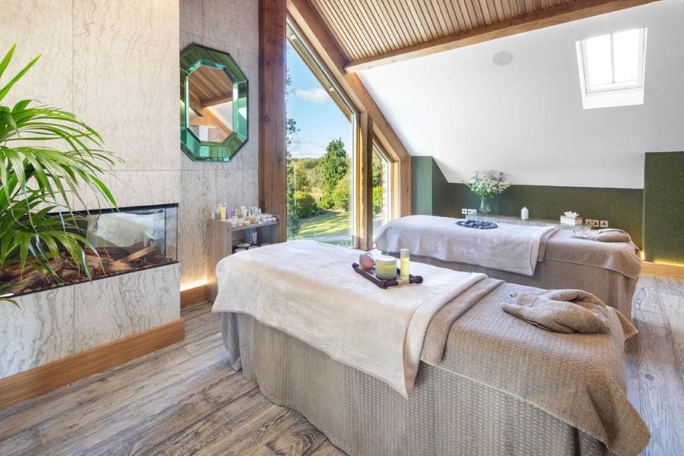 a wellness room with two beds and a large window