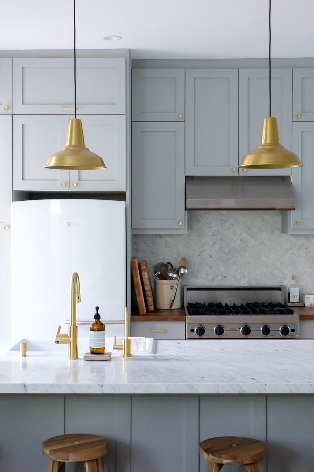gray kitchen with brass pendants