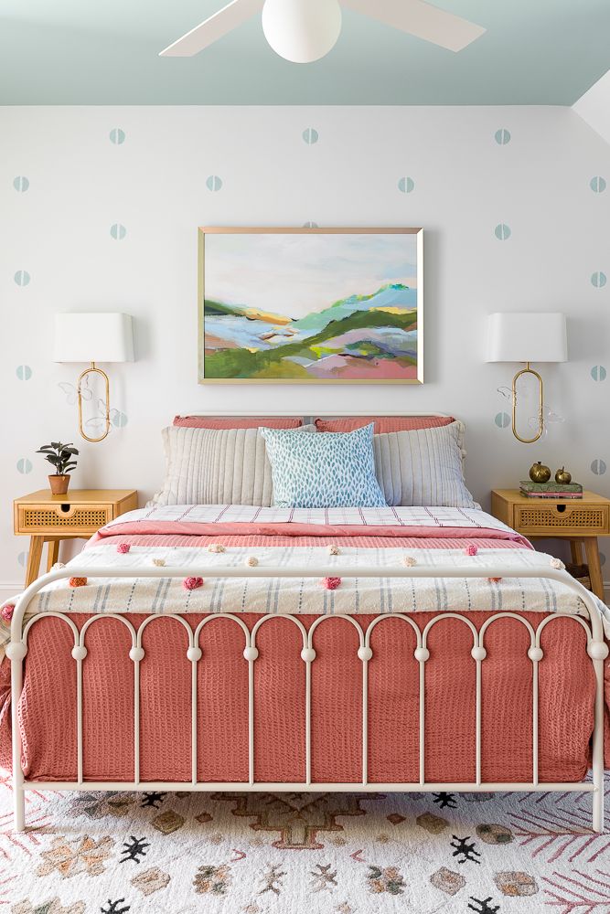a bed with a pink and white bed spread