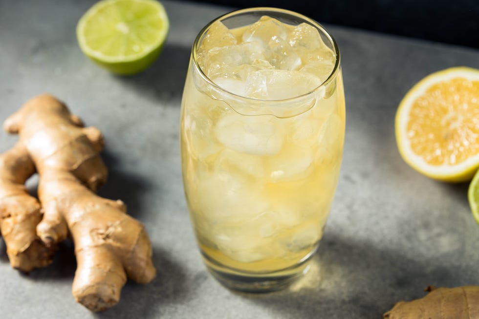 cold refreshing ginger beer in a glass with lime and lemon