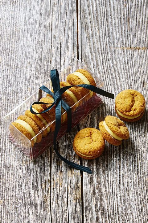 ginger and cream sandwich cookies on a wooden surface