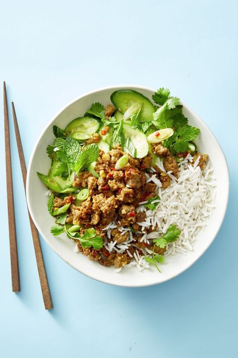 ginger pork, white rice and cucumber salad on a white plate