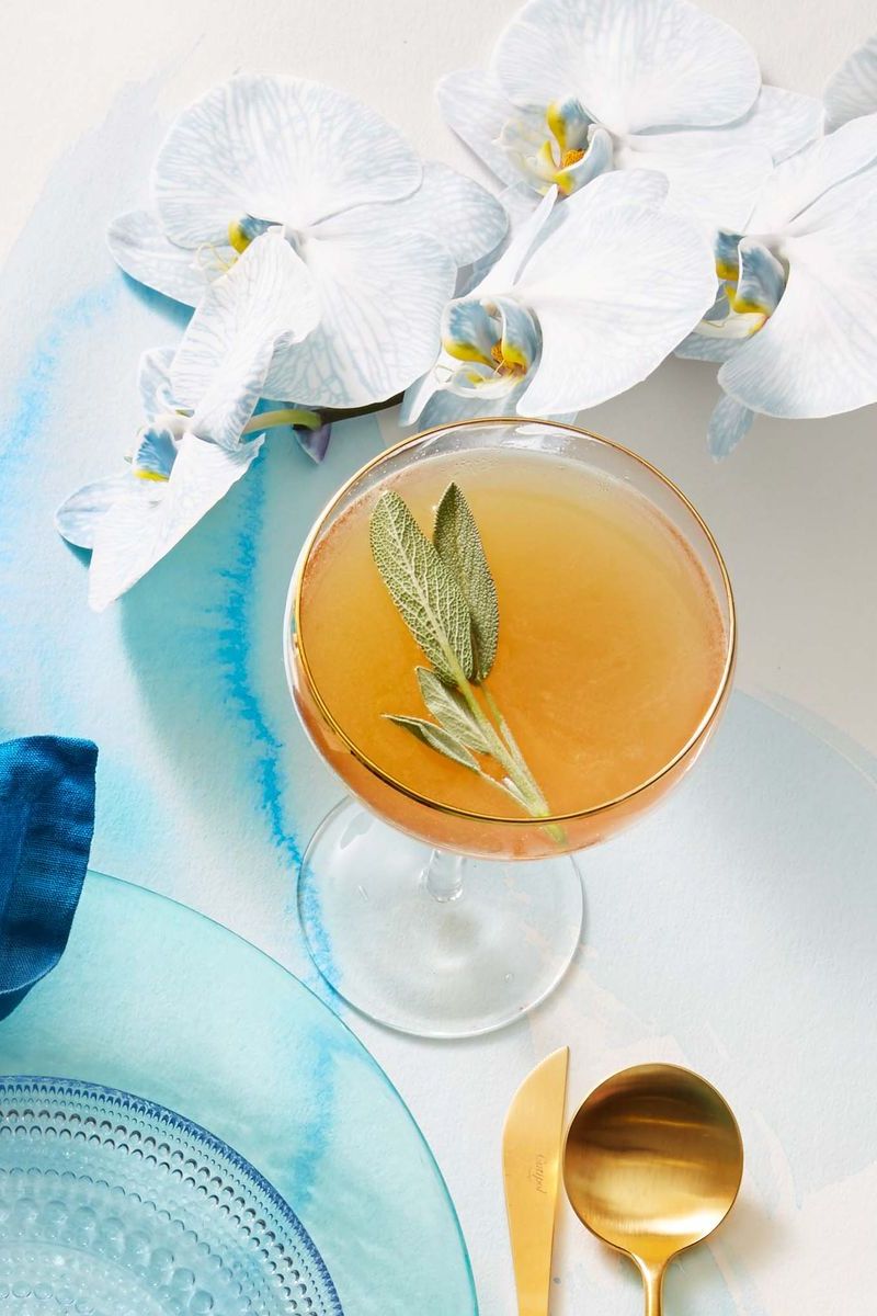 ginger sage rye cocktail on blue stained white paper surface