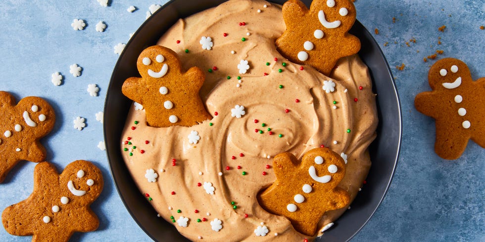 gingerbread flavored cheesecake dip in a bowl topped with sprinkles and gingerbread cookeis