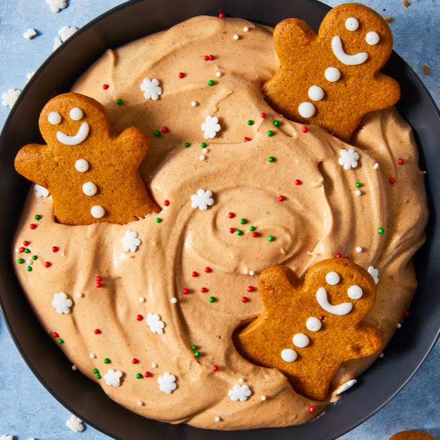 gingerbread flavored cheesecake dip in a bowl topped with sprinkles and gingerbread cookeis