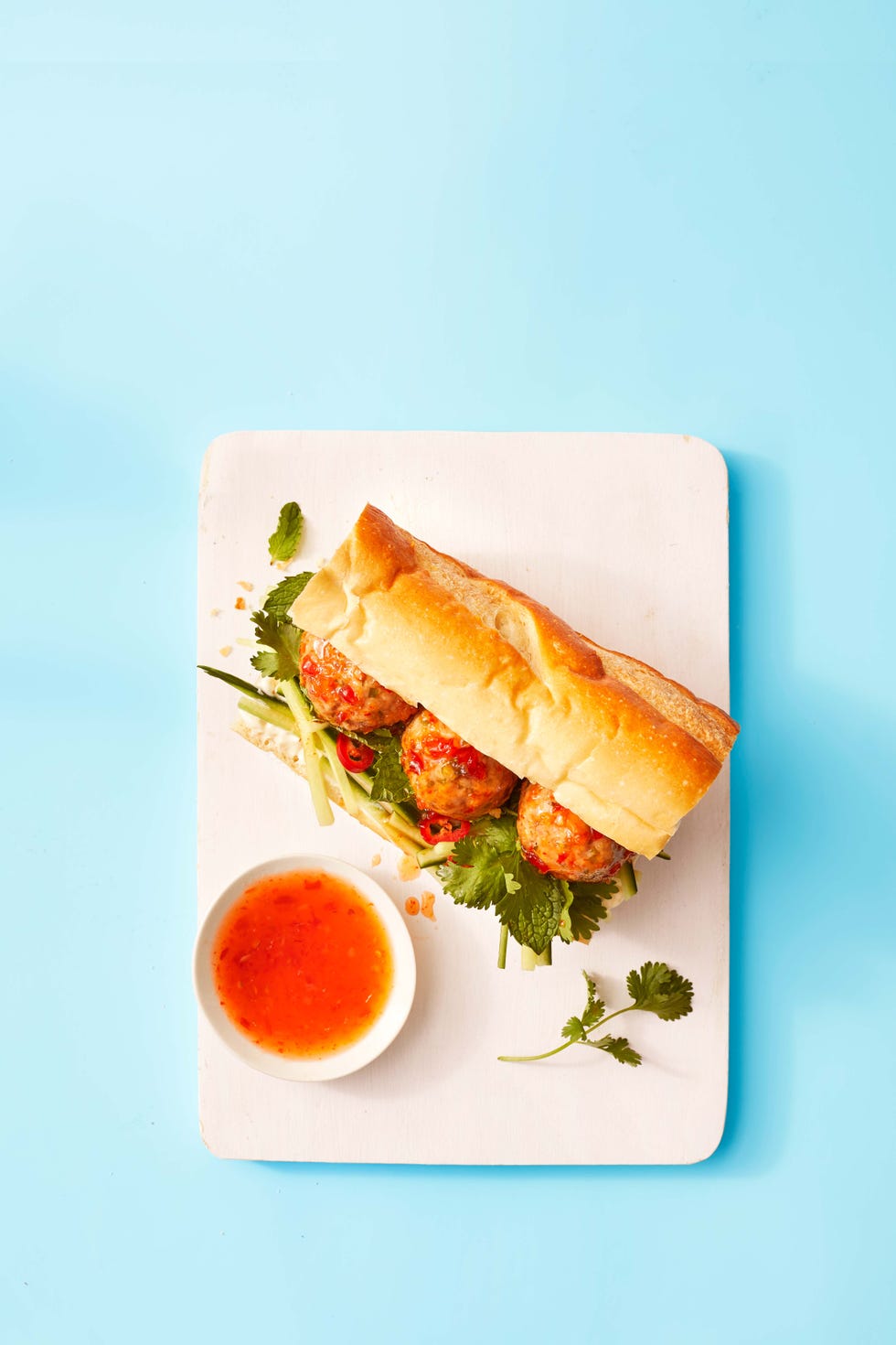 gingery pork meatball sub with a side of dipping sauce