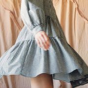 a model spins in a tiered gingham dress in a roundup of the best gingham dresses 2022