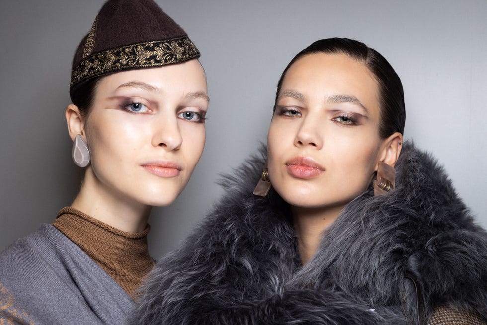 two models showcasing fashion attire with distinct accessories two models showcasing fashion attire with distinct accessories