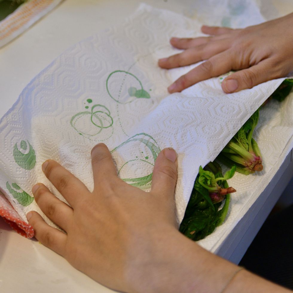 girl dries the vegetables with a sheet of paper to preserve them