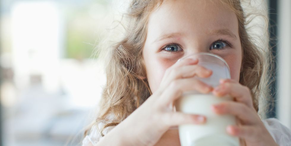 girl drinking glass of milk