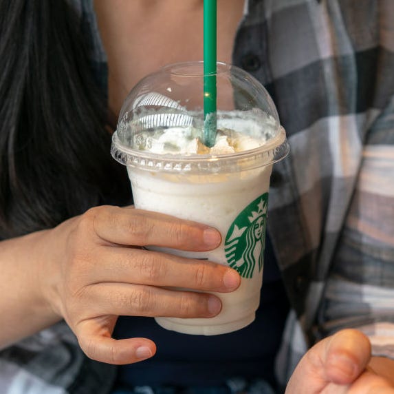 a girl drinks a starbucks coffee