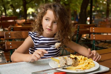 GIRL EATING IN A PARK