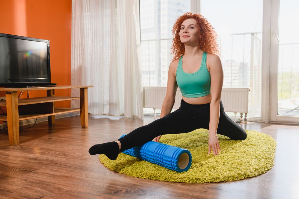 girl exercise with yoga roller at home