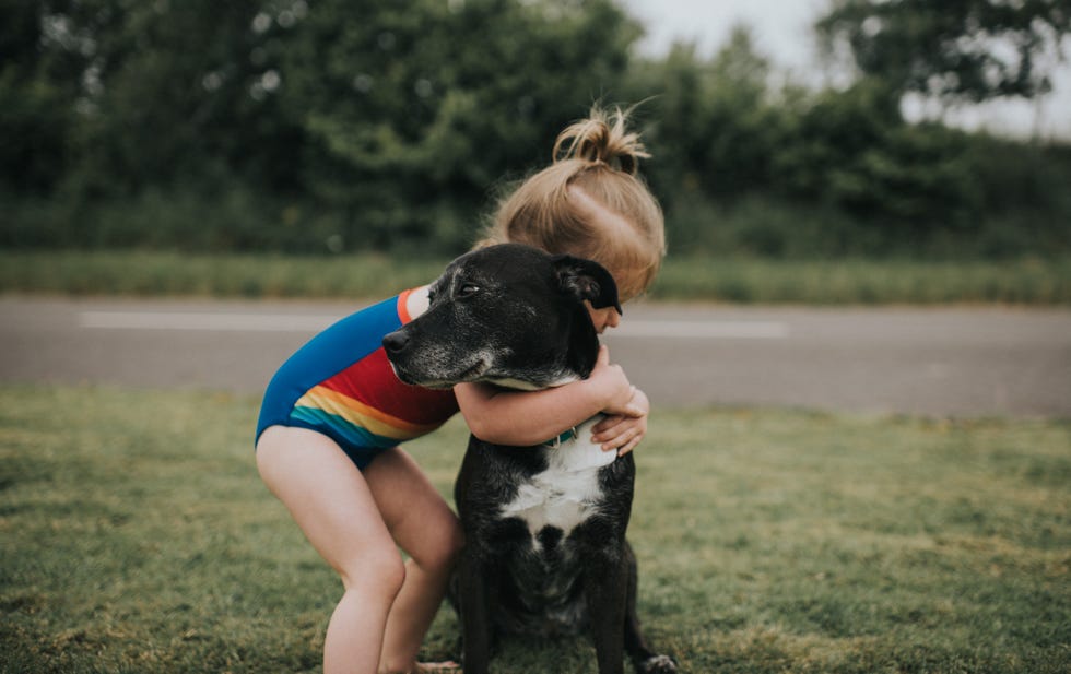 girl hugs dog