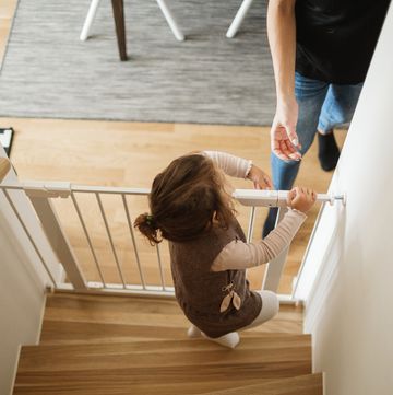 girl opening baby gate in staircase