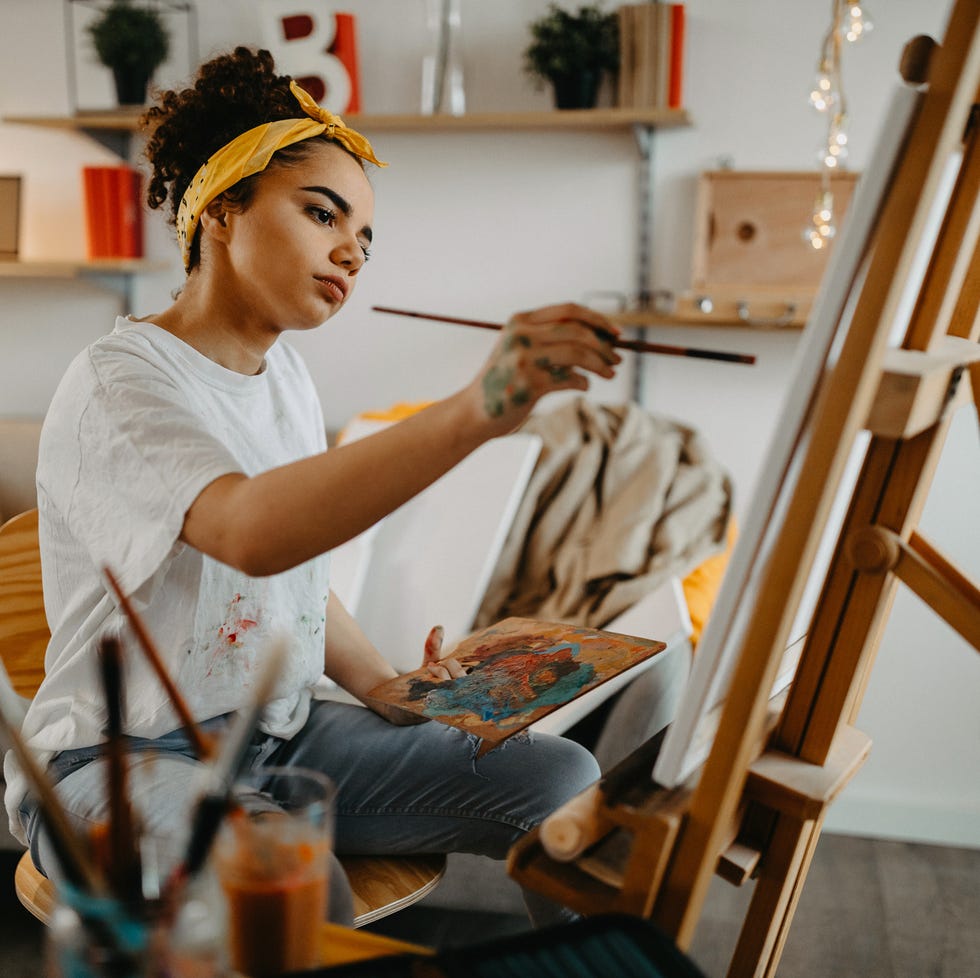 girl painting on canvas