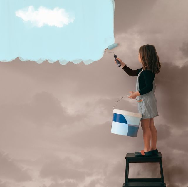girl painting the wall from cloudy  to clear blue sky positive attitude and mentality concept
