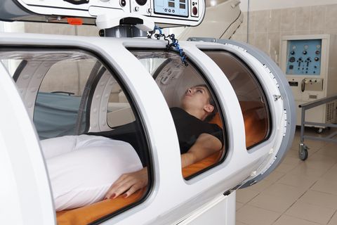 girl patient lying in a hyperbaric chamber