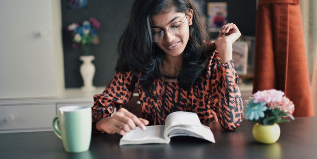 Girl reading book with a coffe mug