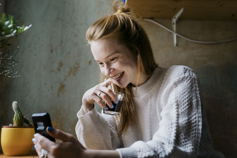 girl relaxing with coffee and video calling partner