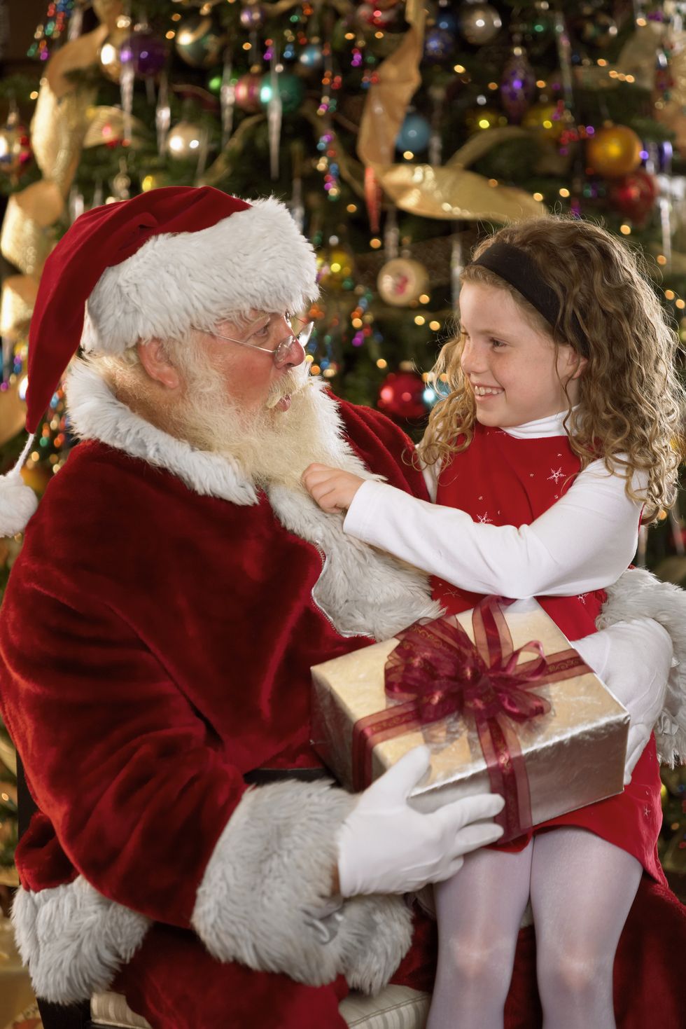 girl sitting with santa claus