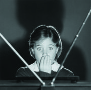girl watching tv, covering mouth