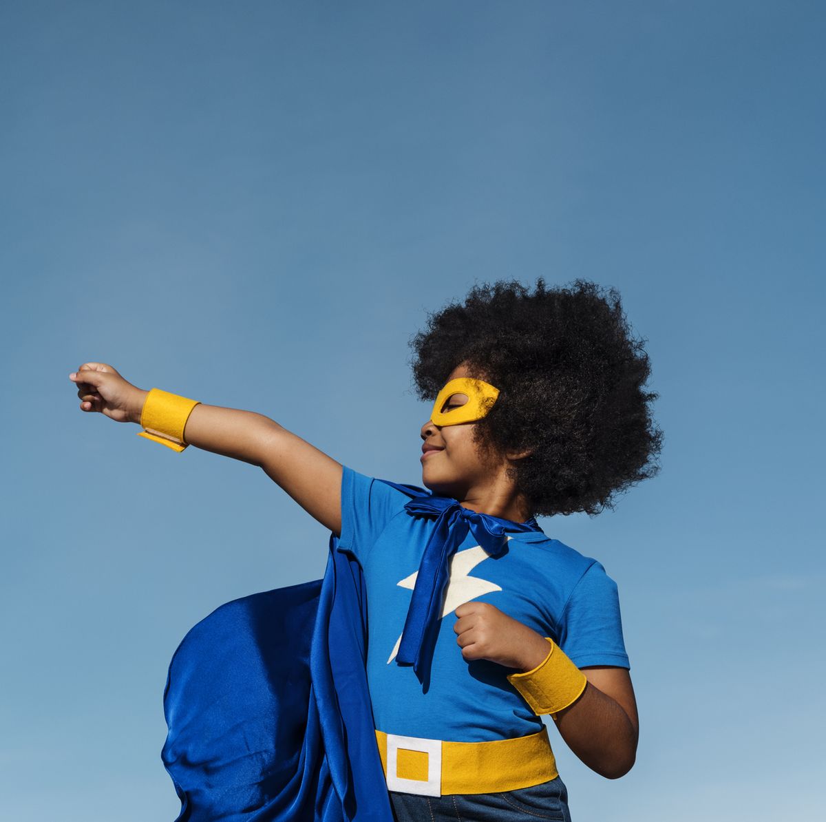 girl with afro playing superhero