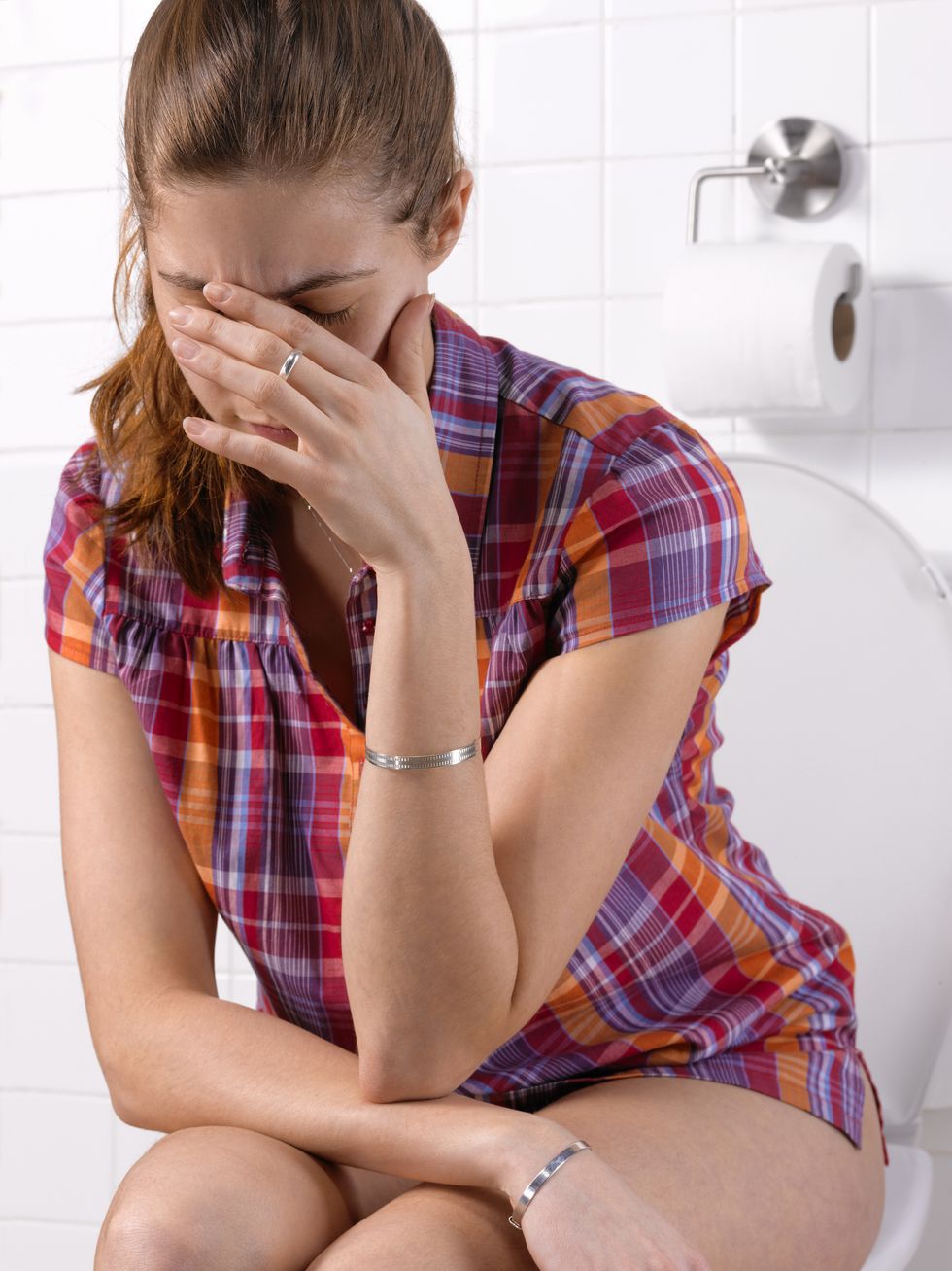 girl with constipation ibs in bathroom