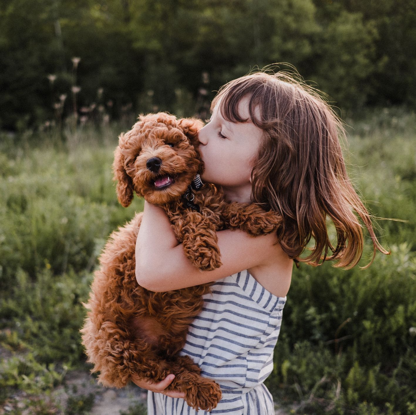 Girl with dog outside playing