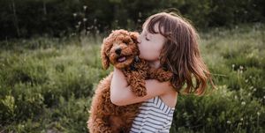Girl with dog outside playing