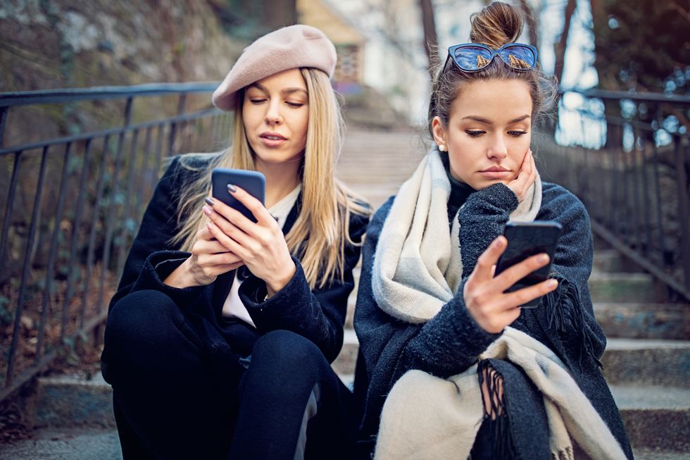Girlfriends in conflict are texting sulking each other