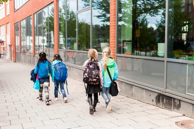 niñas andando con mochilas al colegio