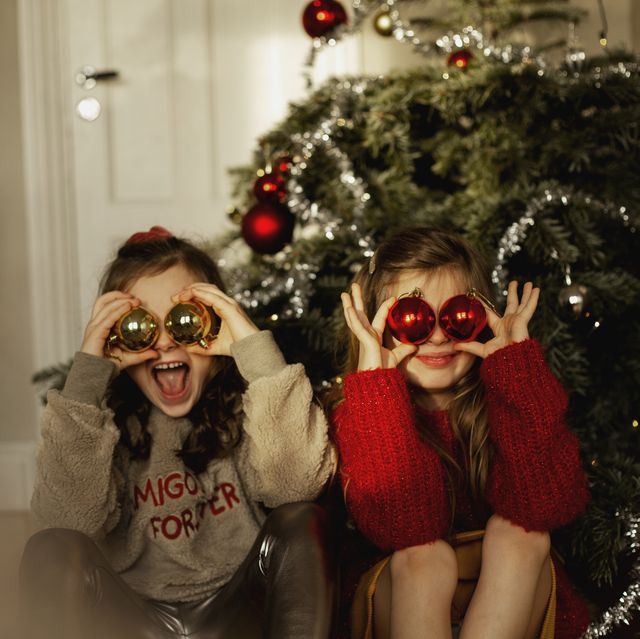 girls in front of christmas tree
