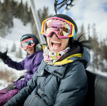 girls laughing and having fun on a chair lift