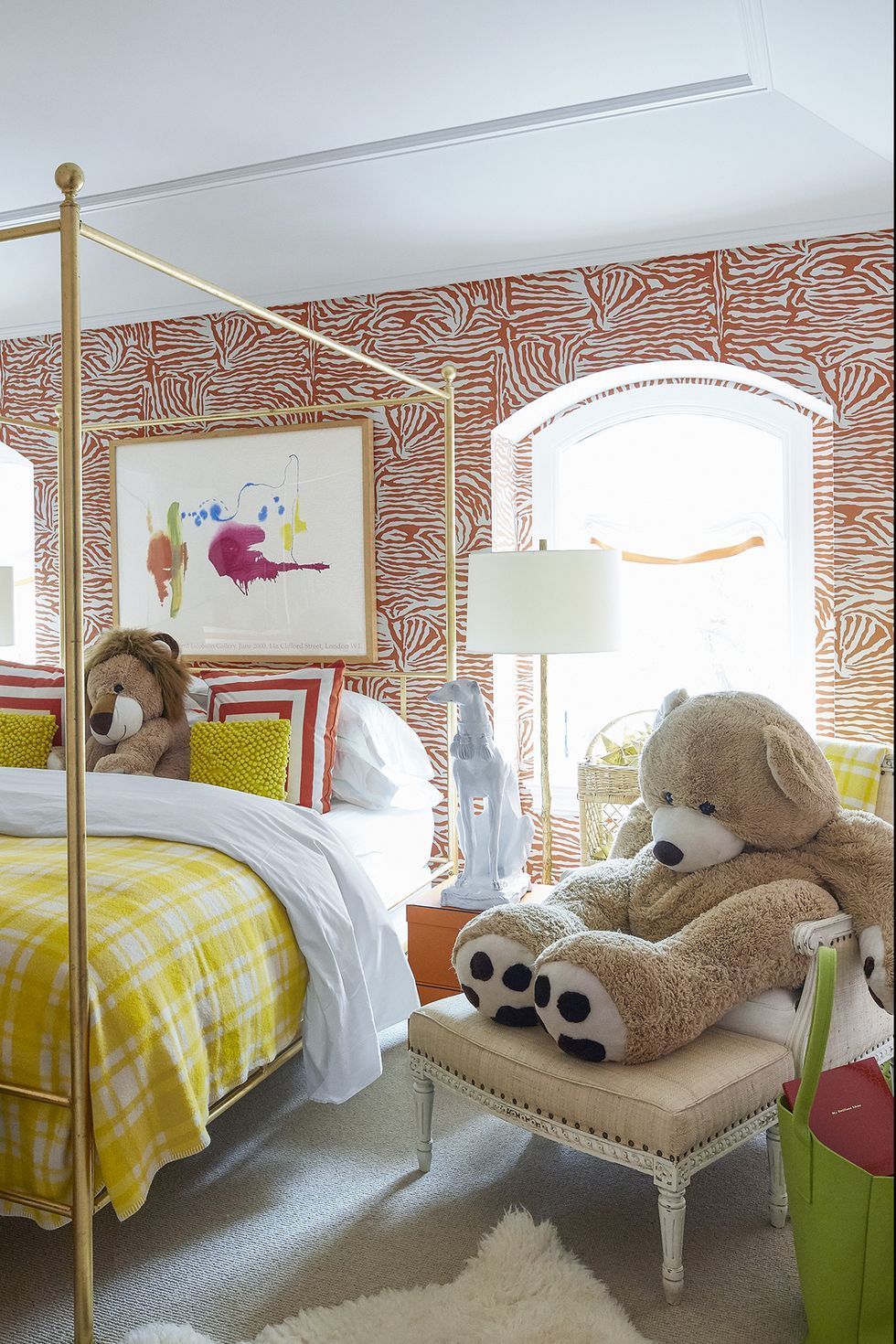 a couple of teddy bears sit on a chair in a bedroom