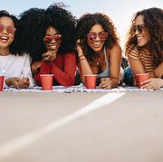 best international and domestic girls trip ideas  group of friends outside smiling and laughing