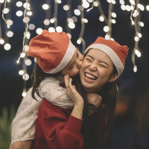 girls wearing santa hats laughing
