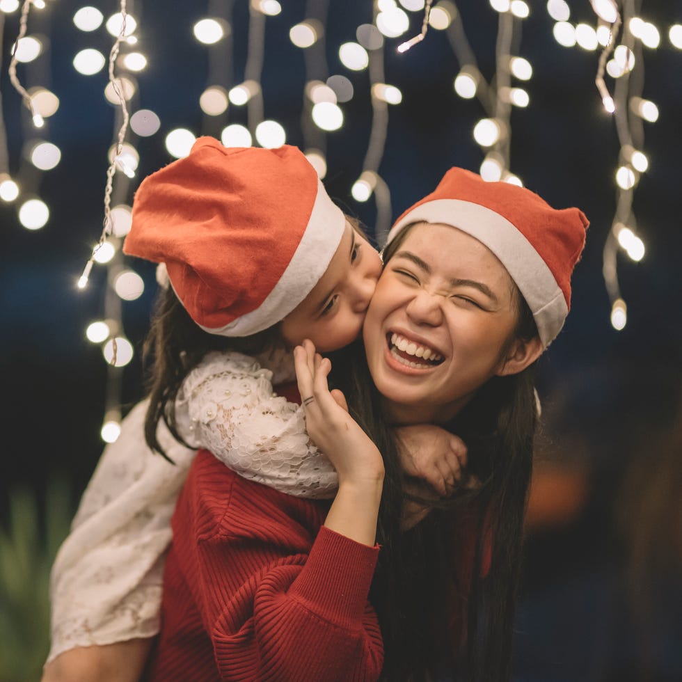 girls wearing santa hats laughing