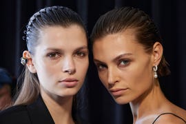 a woman looking at another woman