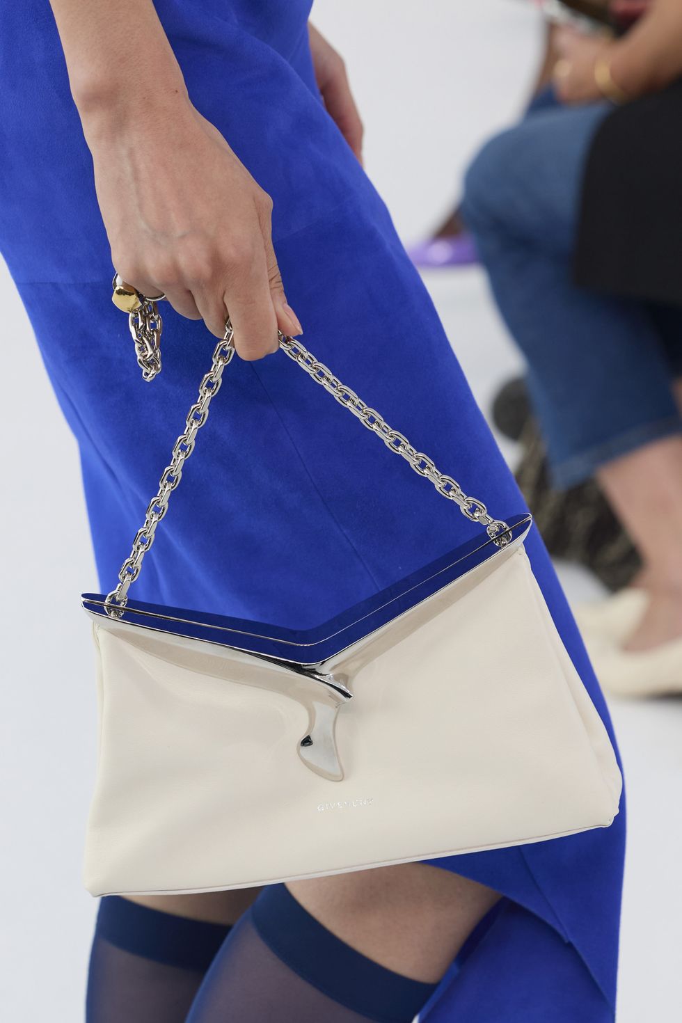 a person carrying a blue purse