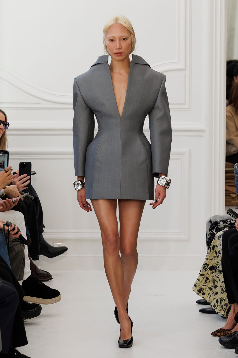 Model showcases a designer outfit on a runway
