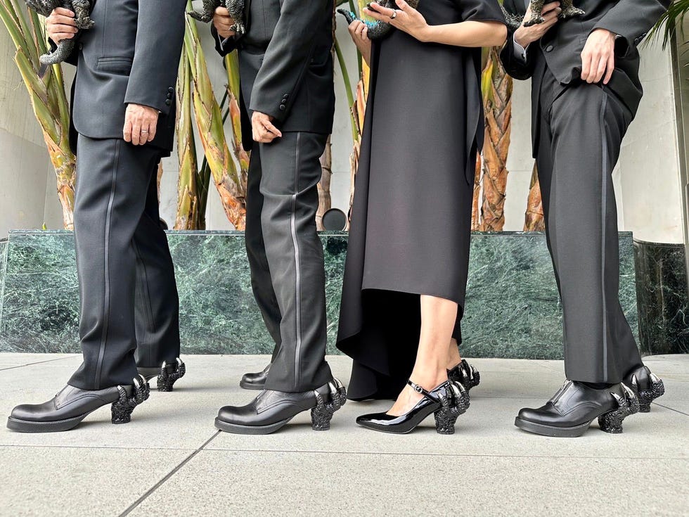 a group of people in black suits