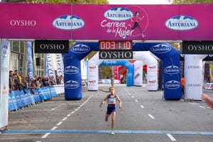 Runner crossing the finish line at a womens race event