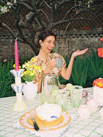 a person sitting at a table with a cake and candles