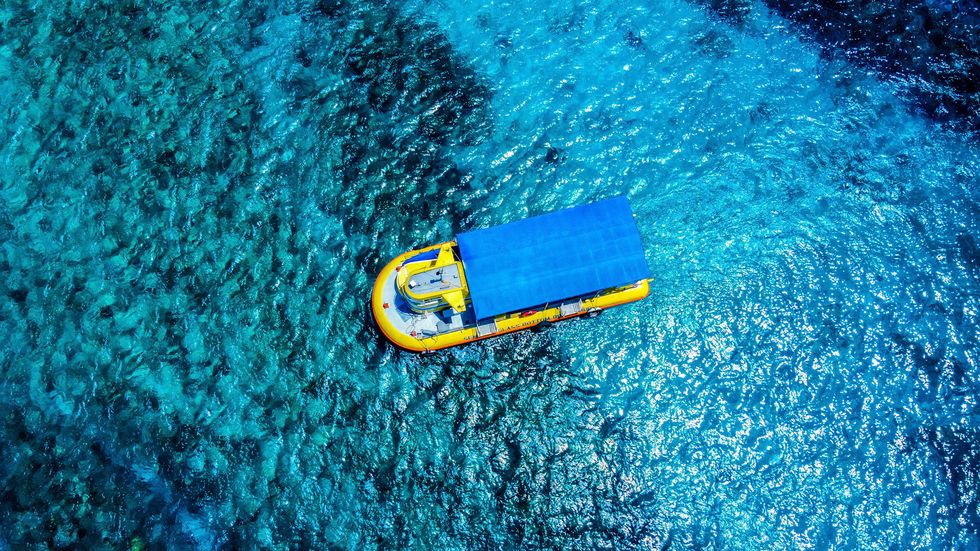 a yellow and blue boat on the ocean