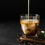 glass cold brew coffee with ice and milk on black or dark background