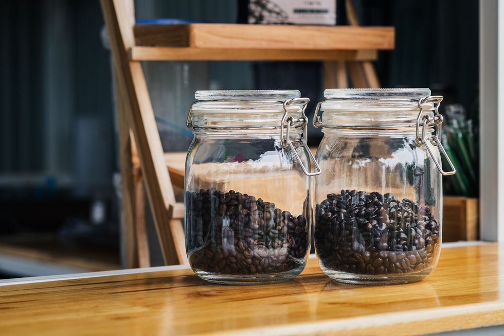 glass jar containing roasted coffee beans