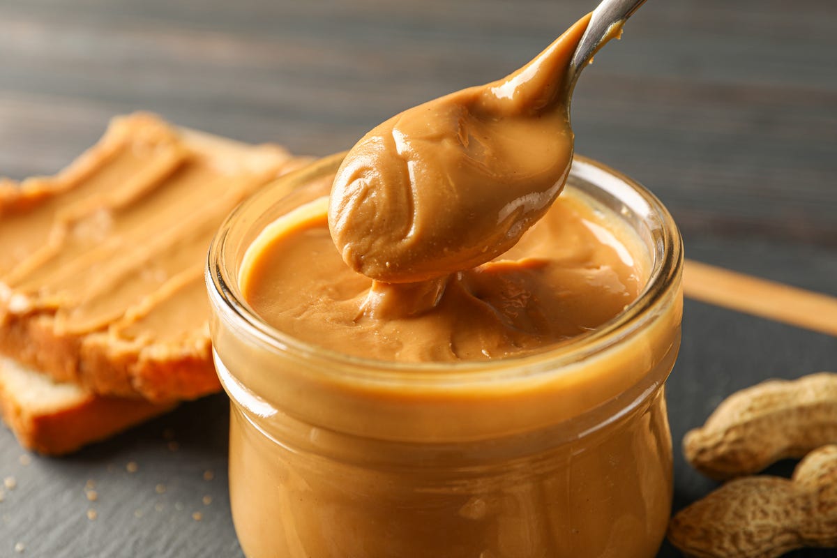 https://hips.hearstapps.com/hmg-prod/images/glass-jar-with-peanut-butter-and-spoon-peanut-royalty-free-image-1698339953.jpg?crop=1xw:0.84415xh;center,top&resize=1200:*